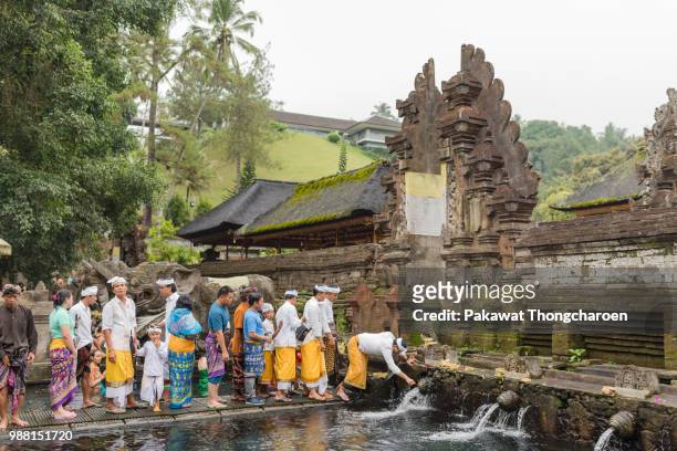 bali, indonesia - june 19, 2018: people washing holy water at pura tirta empul temple - tirta empul temple stock pictures, royalty-free photos & images