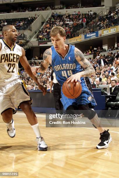 Jason Williams of the Orlando Magic dribble drives baseline against A.J. Price of the Indiana Pacers during the game at Conseco Fieldhouse on April...