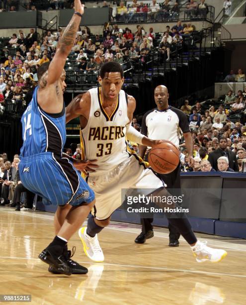 Danny Granger of the Indiana Pacers dribble drives to the basket against Jameer Nelson of the Orlando Magic during the game at Conseco Fieldhouse on...