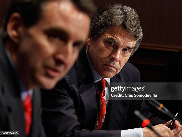 Texas Governor Rick Perry listens to Minnesota Governor Tim Pawlenty as he addresses a U.S. Chamber of Commerce summit on "the role of free...