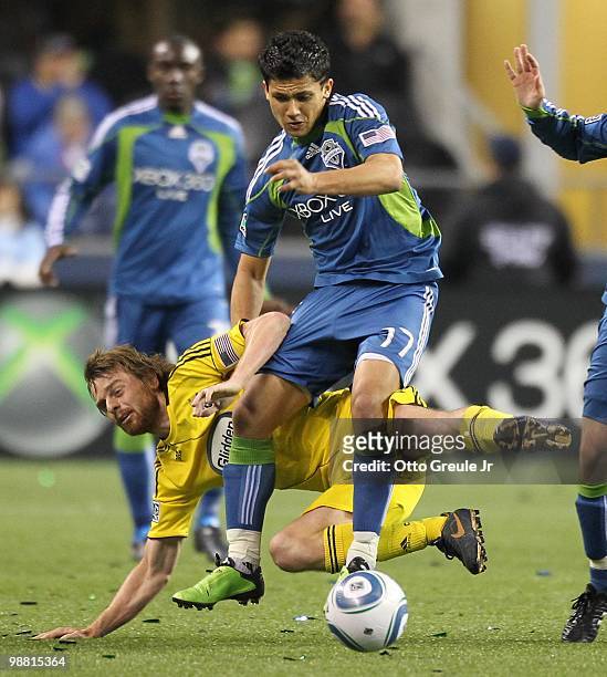 Fredy Montero of the Seattle Sounders FC in action against Eddie Gaven of the Columbus Crew on May 1, 2010 at Qwest Field in Seattle, Washington.