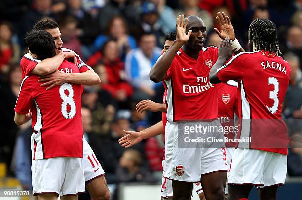 Robin Van Persie of Arsenal celebrates with team mates Samir Nasri and Sol Campbell after scoring the first goal during the Barclays Premier League...