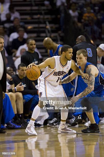 Augustin of the Charlotte Bobcats tries to dribble past Jason Williams of the Orlando Magic at Time Warner Cable Arena in Game Four of the Eastern...