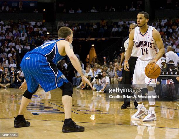 Augustin of the Charlotte Bobcats looks to make a play while being defended by Jason Williams of the Orlando Magic at Time Warner Cable Arena on...