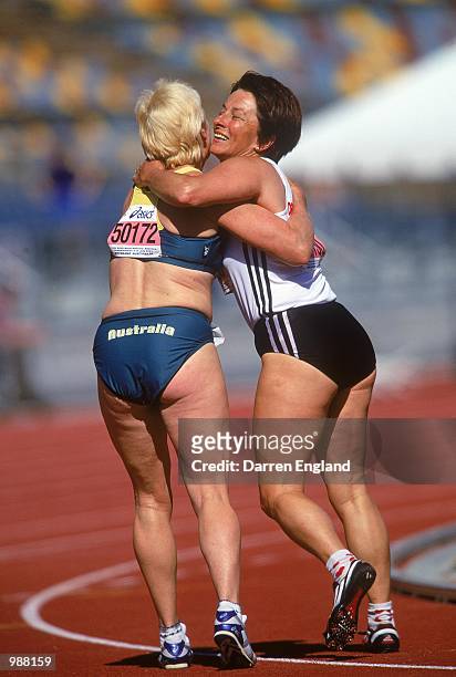 Judy Casey of Australia congratulates Ingrid Meier of Germany after the Women's 4x100m Relay during the World Veterans'' Athletics Championships held...