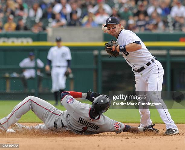 Orlando Hudson of the Minnesota Twins is out at second base while Adam Everett of the Detroit Tigers throws to first base while turning a double play...