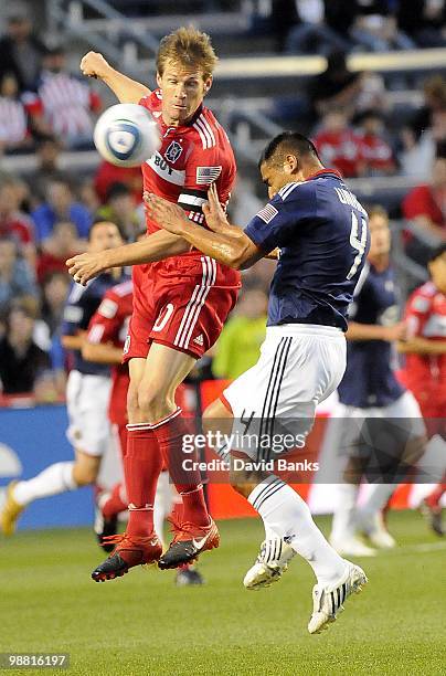 Brian McBride of the Chicago Fire heads the ball forward against Michael Umana of Chivas USA in an MLS match on May 1, 2010 at Toyota Park in...