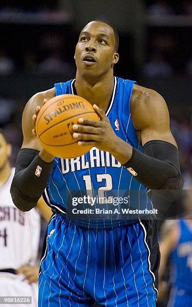 Dwight Howard of the Orlando Magic shoots a free throw in the final minutes of the fourth quarter against the Charlotte Bobcats at Time Warner Cable...