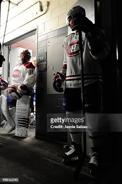 Maxim Lapierre of the Montreal Canadiens waits for goaltender Jaroslav Halak of the Montreal Canadiens to lead the team from the dressing room to the...