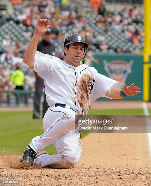 Scott Sizemore of the Detroit Tigers slides safely into home against the Minnesota Twins at Comerica Park on April 29, 2010 in Detroit, Michigan. The...