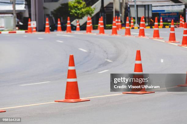 the orange cone is an object of the forbidden parking - traffic cone stock-fotos und bilder