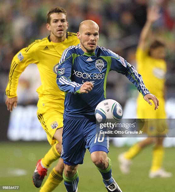 Freddie Ljungberg of the Seattle Sounders FC battles Eric Brunner of the Columbus Crew on May 1, 2010 at Qwest Field in Seattle, Washington. The...