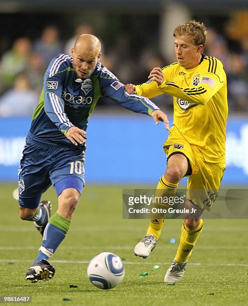 Freddie Ljungberg of the Seattle Sounders FC battles Brian Carroll of the Columbus Crew on May 1, 2010 at Qwest Field in Seattle, Washington.