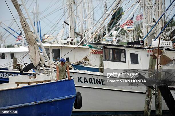 Fisherman watches as a boat docks after making repairs May 3, 2010 in Pass Christian, Mississippi. The fleet are confined to port since the shutdown...