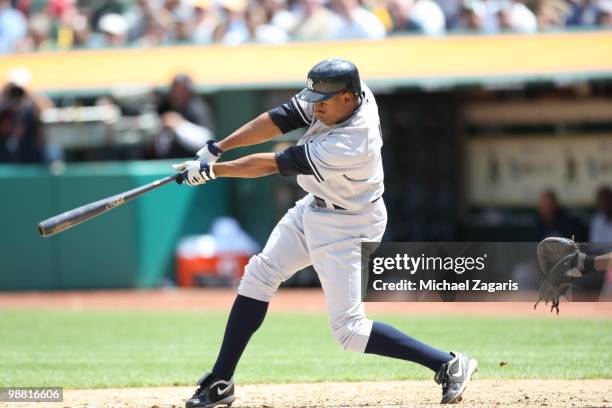 Curtis Granderson of the New York Yankees hitting during the game against the Oakland Athletics at the Oakland Coliseum on April 22, 2010 in Oakland,...