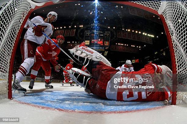 Wojtek Wolski of the Phoenix Coyotes stops next to Henrik Zetterberg of the Detroit Red Wings as teammate Jimmy Howard makes a diving save during...