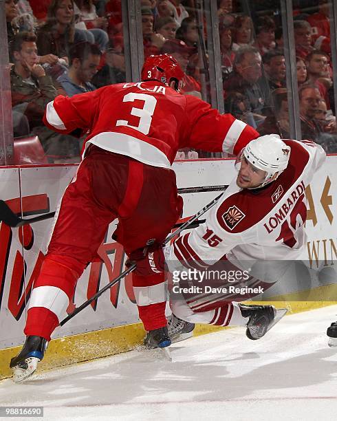 Andreas Lilja of the Detroit Red Wings checks Matthew Lombardi of the Phoenix Coyotes during Game Six of the Western Conference Quarterfinals of the...