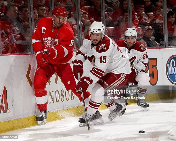 Matthew Lombardi and Wojtek Wolski of the Phoenix Coyotes battle for the puck with Nicklas Lidstrom of the Detroit Red Wings during Game Six of the...