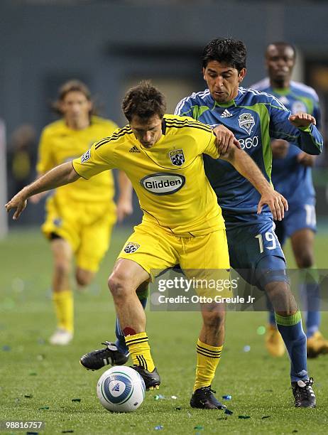 Guillermo Barros Schelotto of the Columbus Crew battles Leonardo Gonzalez of the Seattle Sounders FC on May 1, 2010 at Qwest Field in Seattle,...