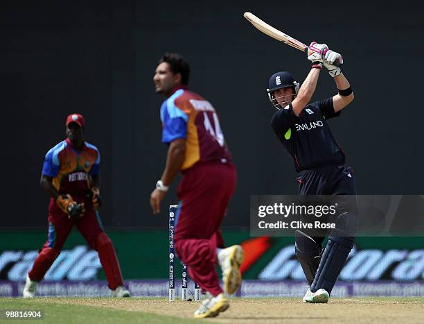 Craig Kieswetter of England hits a six as Ravi Rampaul of West Indies looks on during the ICC T20 World Cup Group D match between West Indies and...