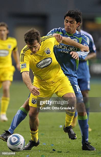 Guillermo Barros Schelotto of the Columbus Crew battles Leonardo Gonzalez of the Seattle Sounders FC on May 1, 2010 at Qwest Field in Seattle,...