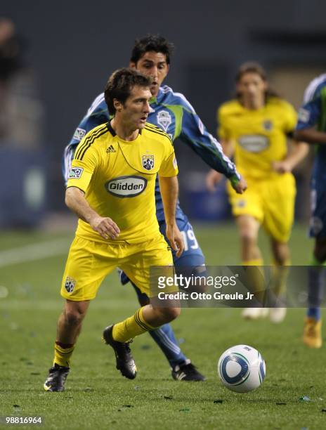 Guillermo Barros Schelotto of the Columbus Crew battles Leonardo Gonzalez of the Seattle Sounders FC on May 1, 2010 at Qwest Field in Seattle,...
