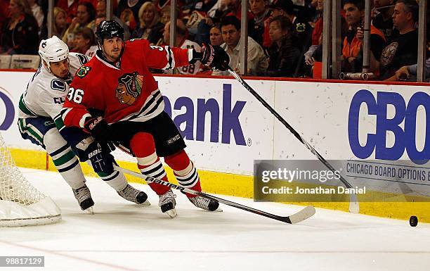 Dave Bolland of the Chicago Blackhawks and Shane O'Brien of the Vancouver Canucks battle for the puck in Game One of the Western Conference...