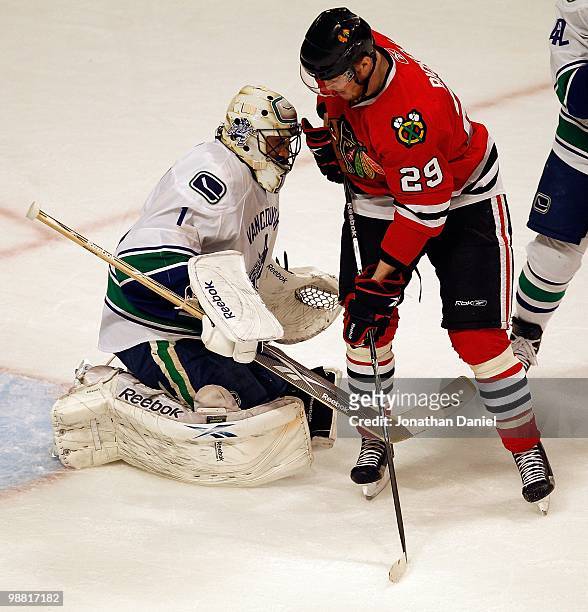 Bryan Bickell of the Chicago Blackhawks confronts Roberto Luongo of the Vancouver Canucks in Game One of the Western Conference Semifinals during the...