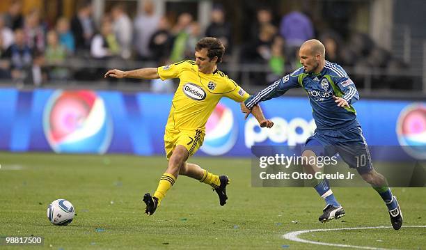 Guillermo Barros Schelotto of the Columbus Crew in action against Freddie Ljungberg of the Seattle Sounders FC on May 1, 2010 at Qwest Field in...