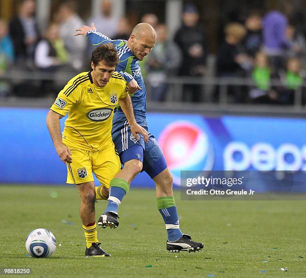 Guillermo Barros Schelotto of the Columbus Crew in action against Freddie Ljungberg of the Seattle Sounders FC on May 1, 2010 at Qwest Field in...