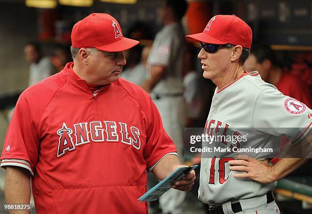 Manager Mike Scioscia and bench coach Ron Roenicke of the Los Angeles Angels of Anaheim talk in the the dugout against the Detroit Tigers during the...