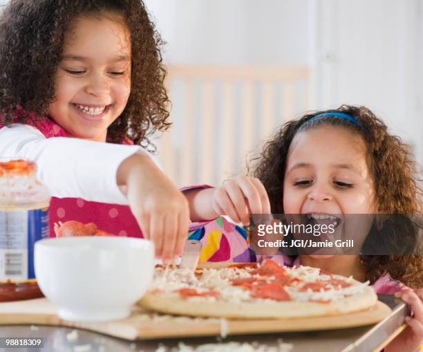 hispanic sisters making pizza - making pizza stock pictures, royalty-free photos & images