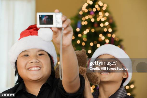 filipino boys taking self-portrait at christmas time - gardena california fotografías e imágenes de stock