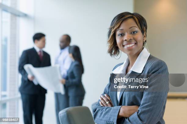 black businesswoman in conference room with co-workers - terry fair stock pictures, royalty-free photos & images