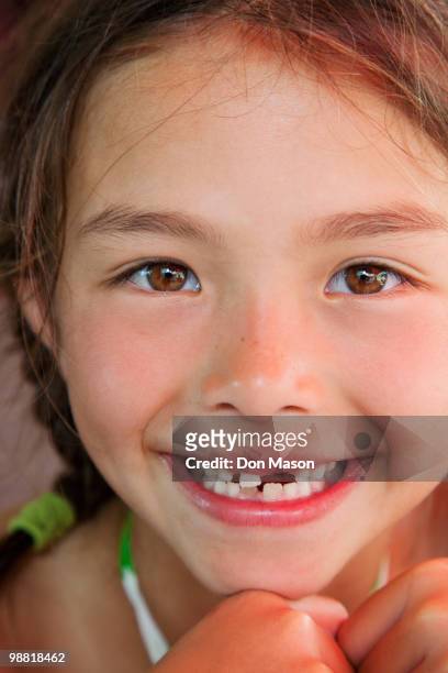 mixed race girl with tooth missing - don mason stock pictures, royalty-free photos & images
