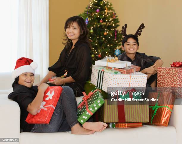 filipino family with stack of christmas gifts - gardena california stock pictures, royalty-free photos & images