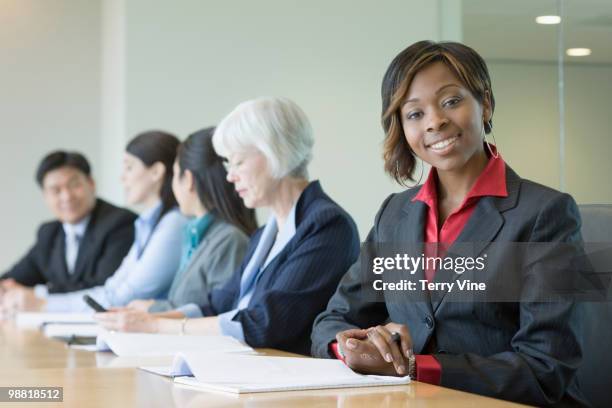 black businesswoman in conference room with co-workers - terry fair stock pictures, royalty-free photos & images