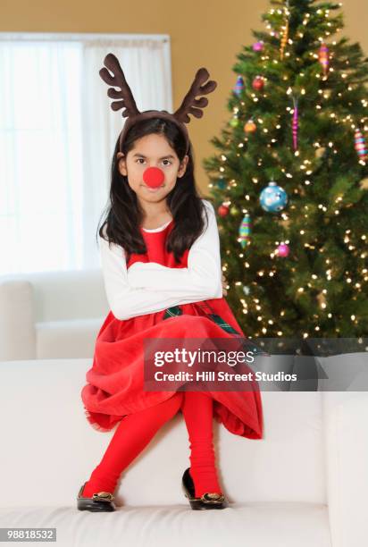 hispanic girl wearing reindeer nose and antlers - animal imitation stock pictures, royalty-free photos & images