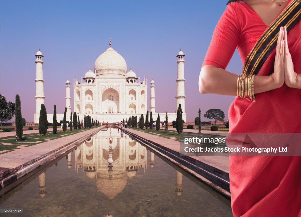 Indian woman in traditional clothing near the Taj Mahal