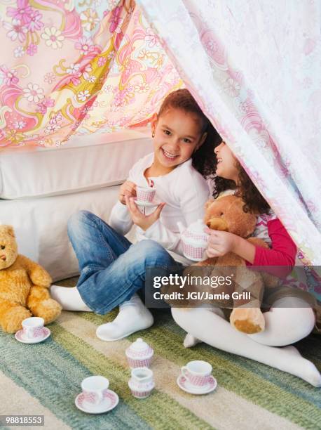 hispanic sisters having tea party - kids fort stock pictures, royalty-free photos & images