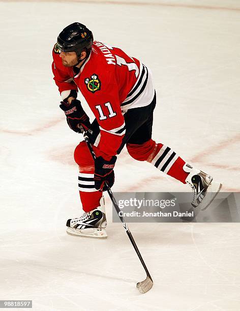 John Madden of the Chicago Blackhawks prepares to shoot against the Vancouver Canucks in Game One of the Western Conference Semifinals during the...