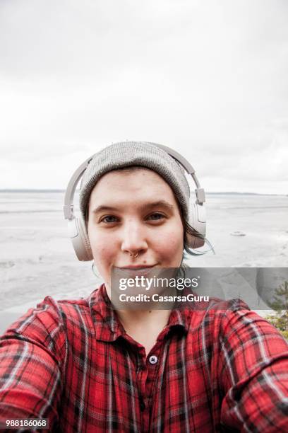 young adult woman taking a selfie in tampere, finland - tampere stock pictures, royalty-free photos & images