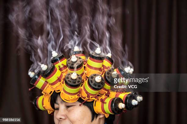 Woman has a head care product applied on her head at a beauty salon on Februarty 1, 2018 in Zhuji, Zhejiang Province of China.