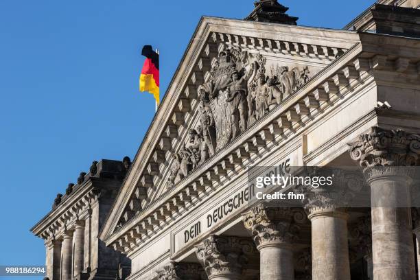 the famous inscription on the architrave on the west portal of the reichstag building in berlin: "dem deutschen volke" (germany) - architrave stock pictures, royalty-free photos & images