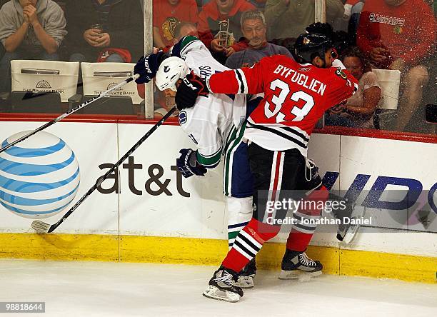 Andrew Alberts of the Vancouver Canucks collides with Dustin Byfuglien of the Chicago Blackhawks in Game One of the Western Conference Semifinals...