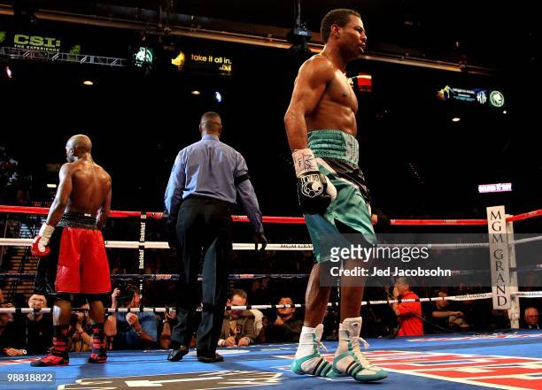 Floyd Mayweather Jr. And Shane Mosley walk back to their corners at the end of a round during their welterweight fight at the MGM Grand Garden Arena...