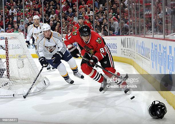 Marian Hossa of the Chicago Blackhawks approaches the puck as Ryan Suter of the Nashville Predators comes up from behind at Game Two of the Western...