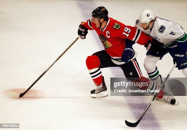 Jonathan Toews of the Chicago Blackhawks tries to hold off Ryan Kesler of the Vancouver Canucks in Game One of the Western Conference Semifinals...