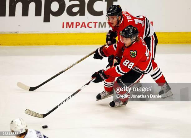 Jonathan Toews and Patrick Kane of the Chicago Blackhawks skate up the ice against the Vancouver Canucks in Game One of the Western Conference...
