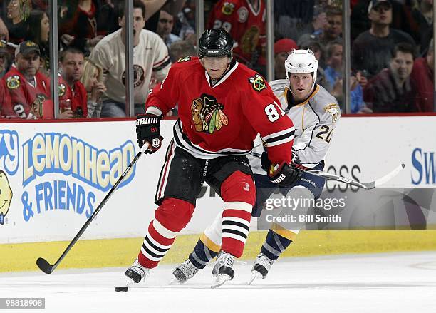 Marian Hossa of the Chicago Blackhawks skates after the puck as Ryan Suter of the Nashville Predators comes up from behind at Game Two of the Western...